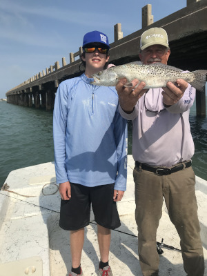 Ryan Falls holding speckled trout in Port Isabel